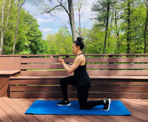 Woman performing forward lunge on exercise mat