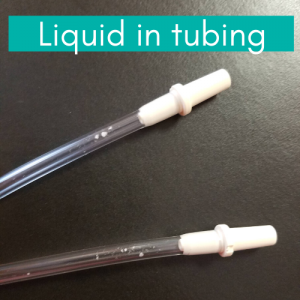 Breast pump tubing with milk in it