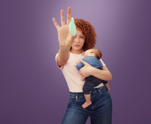 Woman holding newborn and Elvie Trainer